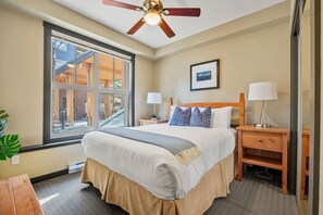 Second bedroom with a queen bed, ceiling fan & closet.