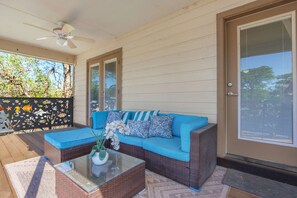 The breezy balcony overlooks the spacious fenced back yard