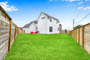 The spacious fenced back yard offers ample space for relaxation & play
