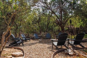 Nestled amongst the trees, the fire pit feels like you are inside a state park. Gather around, come prepared for smores and fun