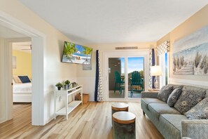 The Living Area features a flat-screen TV and access to the deck, perfect for enjoying those cool breezes right off the ocean.