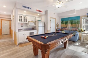 For entertainment and convenience, the Ground Level features a spacious Game Room with a pool table, wet bar, and a half bathroom.