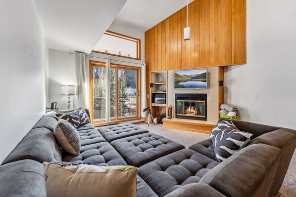 Living Room: 55” Smart TV with cable, gas fireplace, radiant heating, no A/C