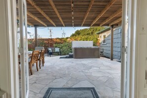 Outside dining, jacuzzi, and spacious area.