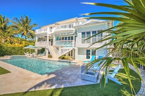 This estate has it all! Saltwater pool with wading area, spa, 100 ft of dock, fire table, summer kitchen and grill, bicycles, ping pong table, kayaks and SUP boards, MORE! 