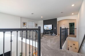 The second-floor LOFT is a cozy and inviting space designed for relaxation and entertainment. It features a comfortable sectional sofa and a large Smart TV, making it the perfect spot for movie nights, gaming, or unwinding after a long day. Whether you're spending quality time with family or simply enjoying a quiet moment, this spacious loft provides a comfortable retreat for everyone.







