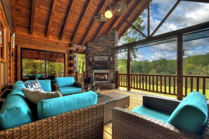 This incredible Lake front cabin rental has a large outdoor fireplace to cozy up in front of each night