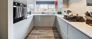 FULLY EQUIPPED KITCHEN READY FOR HOME-COOKED MEALS