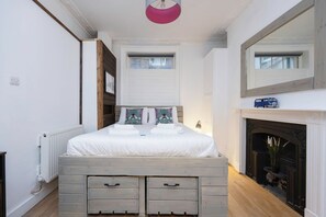 The bespoke made king size bed has incredible storage underneath