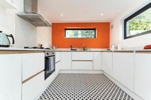 The contemporary modern kitchen is fully equipped with everything you might need to cook a brunch or dinner for friends or family - including a gas hob, oven, Dualit toaster, dishwasher, washing machine and tumble dryer. 