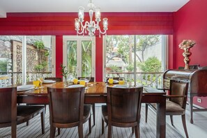 Enjoy vibrant meals in a colourful dining space with garden views, perfect for gatherings.