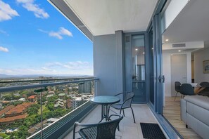 The open plan living and dining area flows to the balcony, creating a seamless transition between indoors and out.