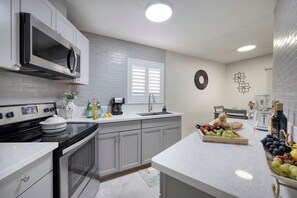 Freshly renovated kitchen with stainless steel appliances and a separate mini bar.  