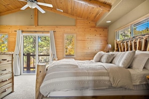 Head to the master bedroom featuring a king size bed and direct balcony access.