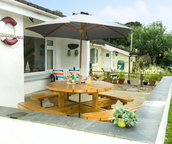 Patio with picnic table, umbrella and bench
