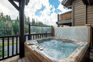 Deck off the living room with a private hot tub