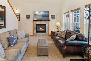 Living room with cozy fireplace and flat screen TV