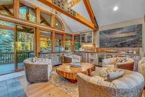Living Room: Sitting area, impressive wet bar, wine cooler, 85” Smart TV, upper floor