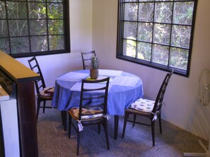 Open concept dining room and kitchen with stove and cooking essentials.