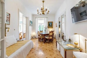 This is a living room with a big table for eating, studying, working...