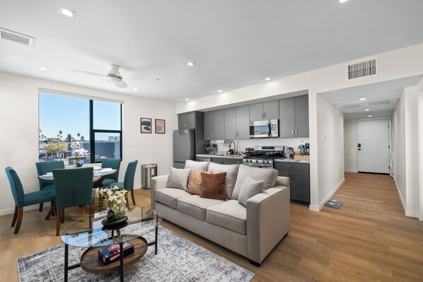 Relax in our spacious living room featuring plush seating, and abundant light.