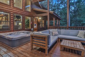 Relax in the hot tub or cozy up on the outdoor sofa, surrounded by the peaceful embrace of nature.