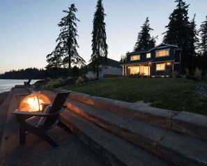 Cozy fireside vibes by the beach—pure relaxation awaits.