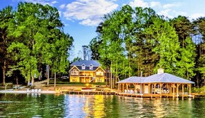 Stunning lakeside retreat with a private dock, gazebo, and luxurious cabin surrounded by lush trees