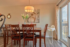 Open concept kitchen/dining room for cooking and entertaining. Upper deck with patio table with umbrella and natural gas BBQ.