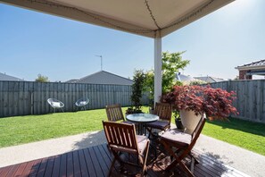 Outside deck with access to lawned back yard