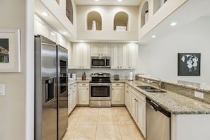 Enjoy a fully equipped kitchen with a sleek double-door fridge, perfect for cooking and entertaining.