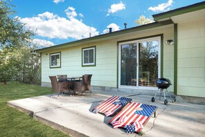Private backyard with a cornhole set and grill!