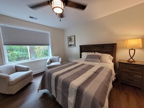 Bedroom 1 with queen bed and sitting area.