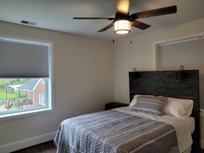 Bedroom 2 with queen bed and desk.