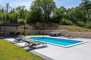 A relaxing area by the pool with a panoramic view