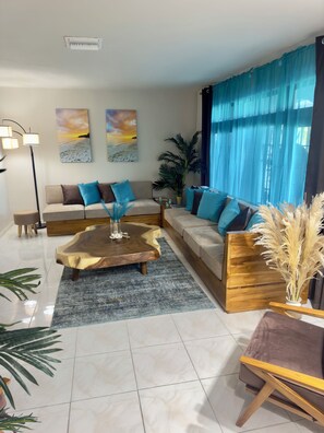 Spacious and Inviting Living Room blends comfort, style, & Bahamian charm.