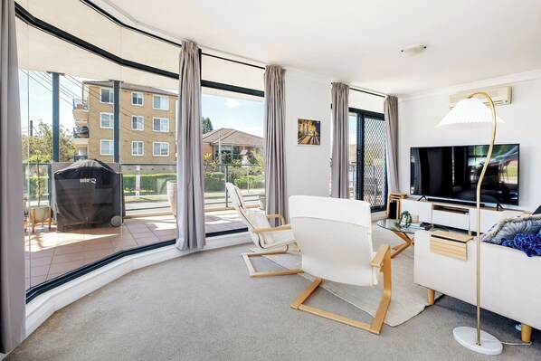 After a day at the beach, unwind on the sofa with some TV or a book in the inviting, open-plan living area. 