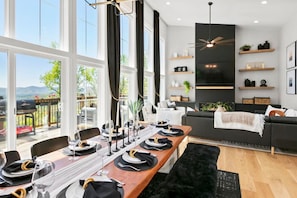 Dine with a view! This elegant dining area offers panoramic mountain vistas and seamlessly connects to the living space. Perfect for memorable meals and gatherings.