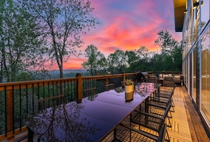Imagine ending your day with this view! Our deck transforms into a magical dining space at sunset, offering a front-row seat to Blue Ridge Mountain's spectacular scenery. The expansive table and comfortable seating create the perfect setting for unforgett