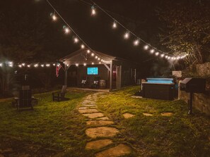 The Backyard: Has a 4 person hot tub, fire pit with chairs and the Whiskey House