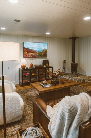 The living area of the cottage has a Jotul wood stove and plenty of games and tv