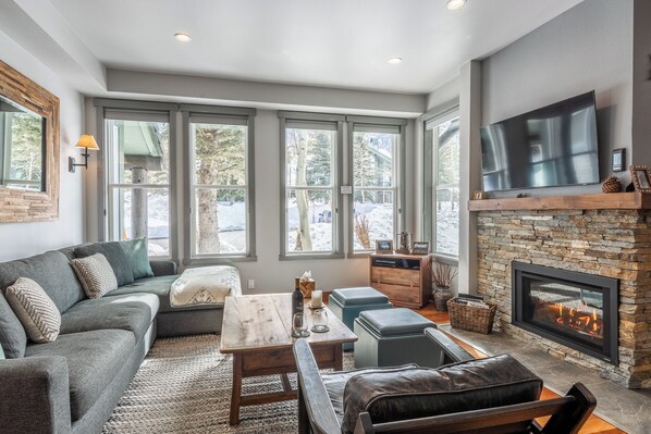 Gorgeous living room with south facing windows and views of the Sherwin Mountains.