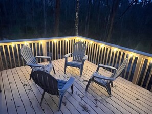 Deck with adirondack chairs &  railings with decorative lighting