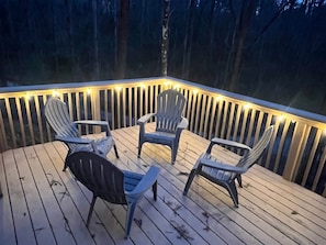 Deck with adirondack chairs & railings with decorative lighting