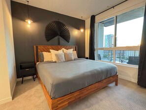 Cozy bedroom featuring a king-size bed and workstation