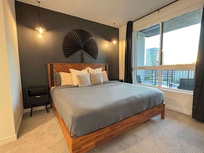 Cozy bedroom featuring a king-size bed and workstation