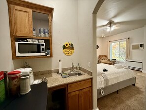 Kitchenette with the essentials:  microwave, refrigerator, sink and coffee maker