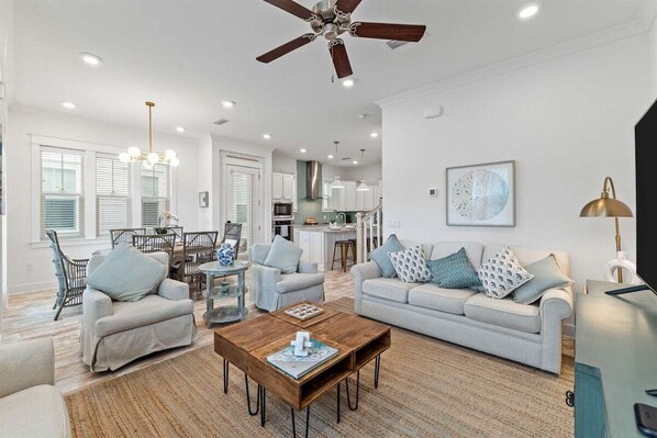 A beautifully designed open-concept living space featuring plush seating, warm lighting, and elegant decor for ultimate relaxation.