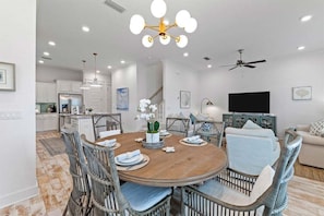 A stylish dining space with comfortable seating, a chic chandelier, and an inviting atmosphere for shared meals.