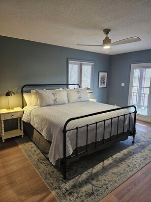 Primary bedroom with bathroom and patio doors.